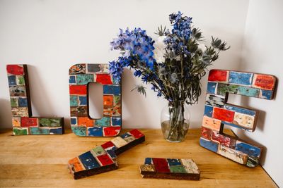 A table with some colorful letters and flowers