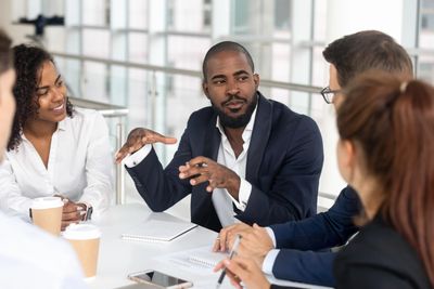 A group of people sitting around a table.